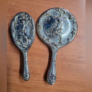 vintage Art Nouveau cherub-themed vanity mirror and brush set